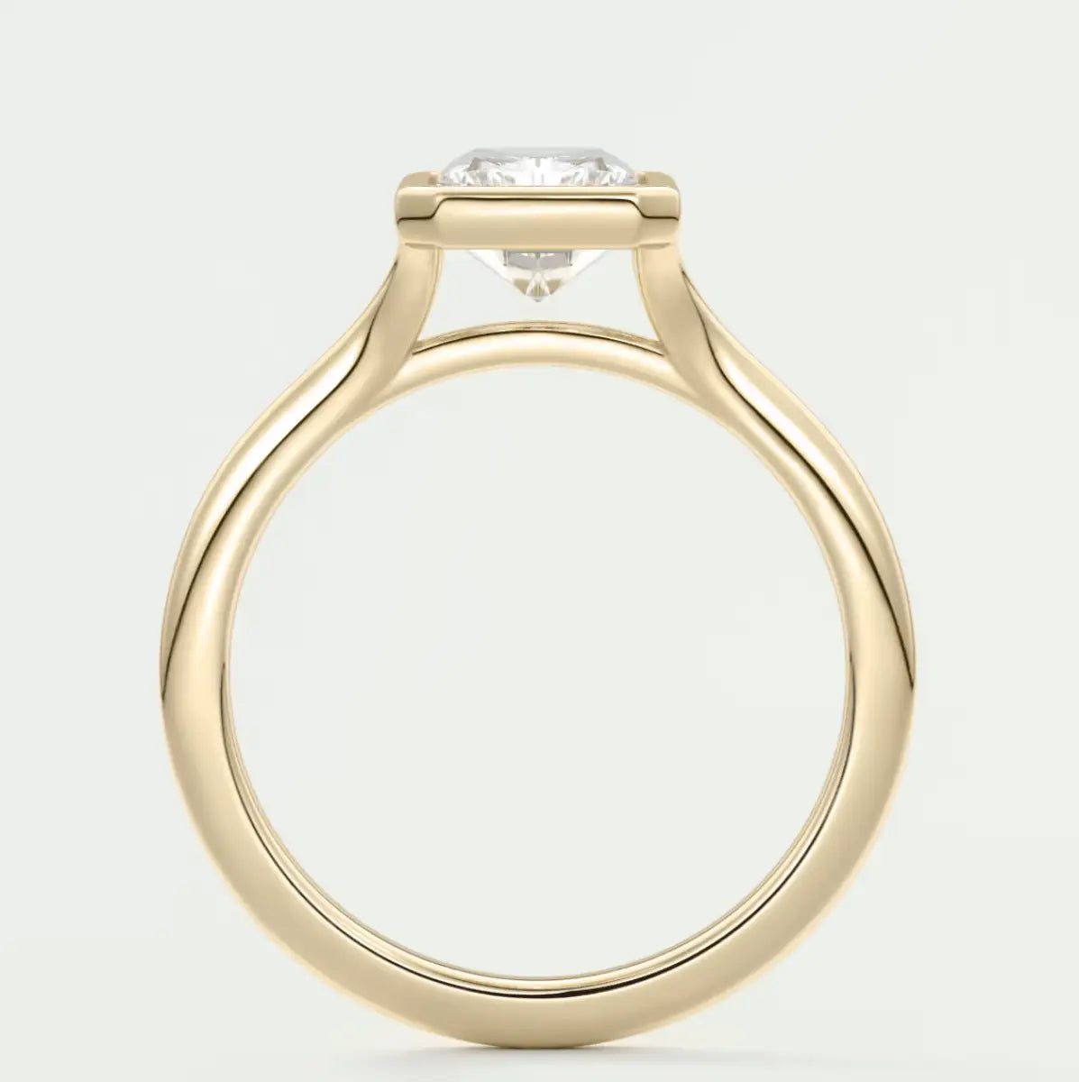 18-karat yellow gold solitaire engagement ring with a round diamond.
