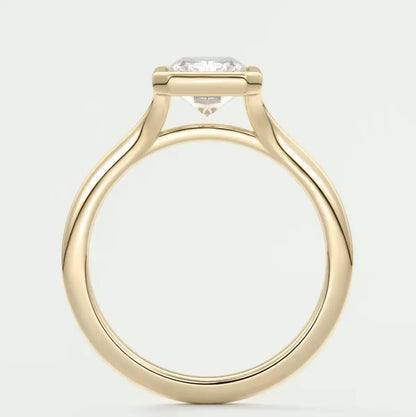 18-karat yellow gold solitaire engagement ring with a round diamond.