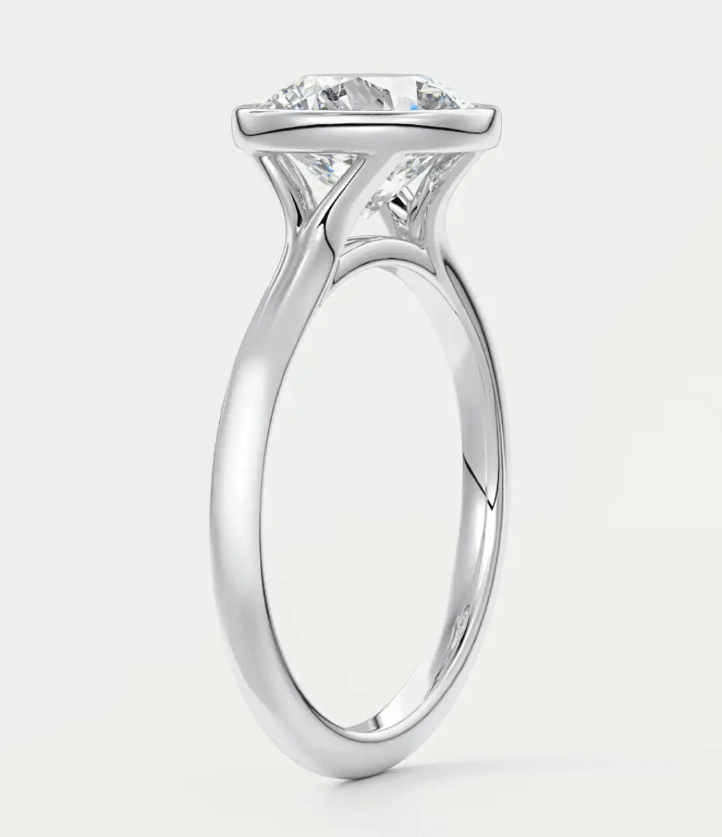 18-karat white gold solitaire engagement ring with a princess-cut diamond.