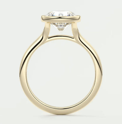 18-karat yellow gold solitaire engagement ring with a round diamond.
