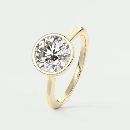 18-karat yellow gold solitaire diamond engagement ring.