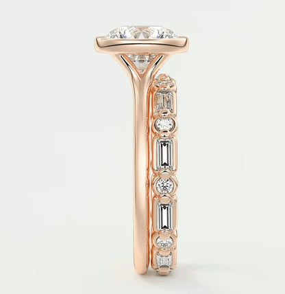 18-karat rose gold engagement ring with a cushion-cut diamond center and baguette diamonds along the band.