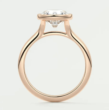 18-karat rose gold engagement ring with a cushion-cut diamond.