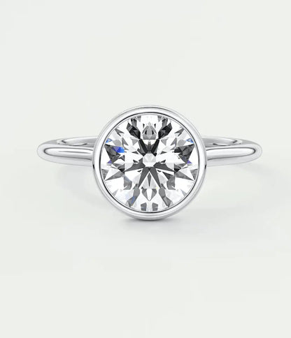 18-karat white gold solitaire diamond engagement ring with a round-cut center stone.