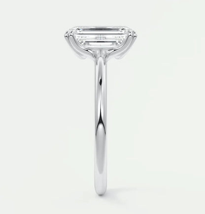 18-karat white gold engagement ring with an emerald-cut diamond.