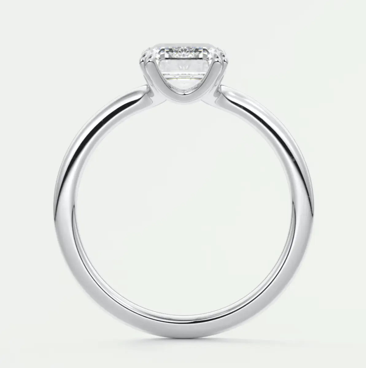 White gold engagement ring with a princess cut diamond and small diamonds on the band.