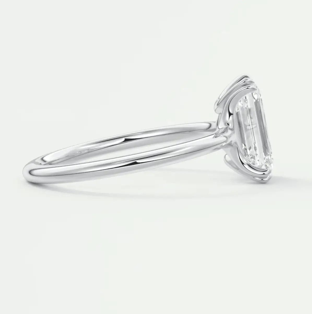 18-karat white gold emerald-cut diamond engagement ring.