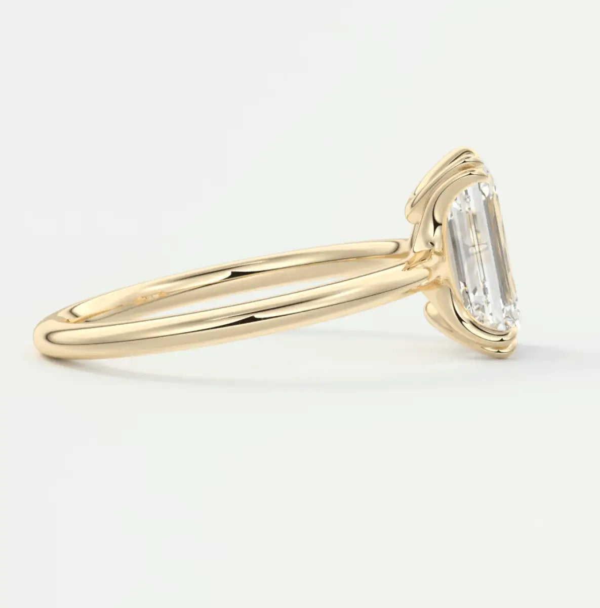 18k yellow gold emerald-cut diamond engagement ring.