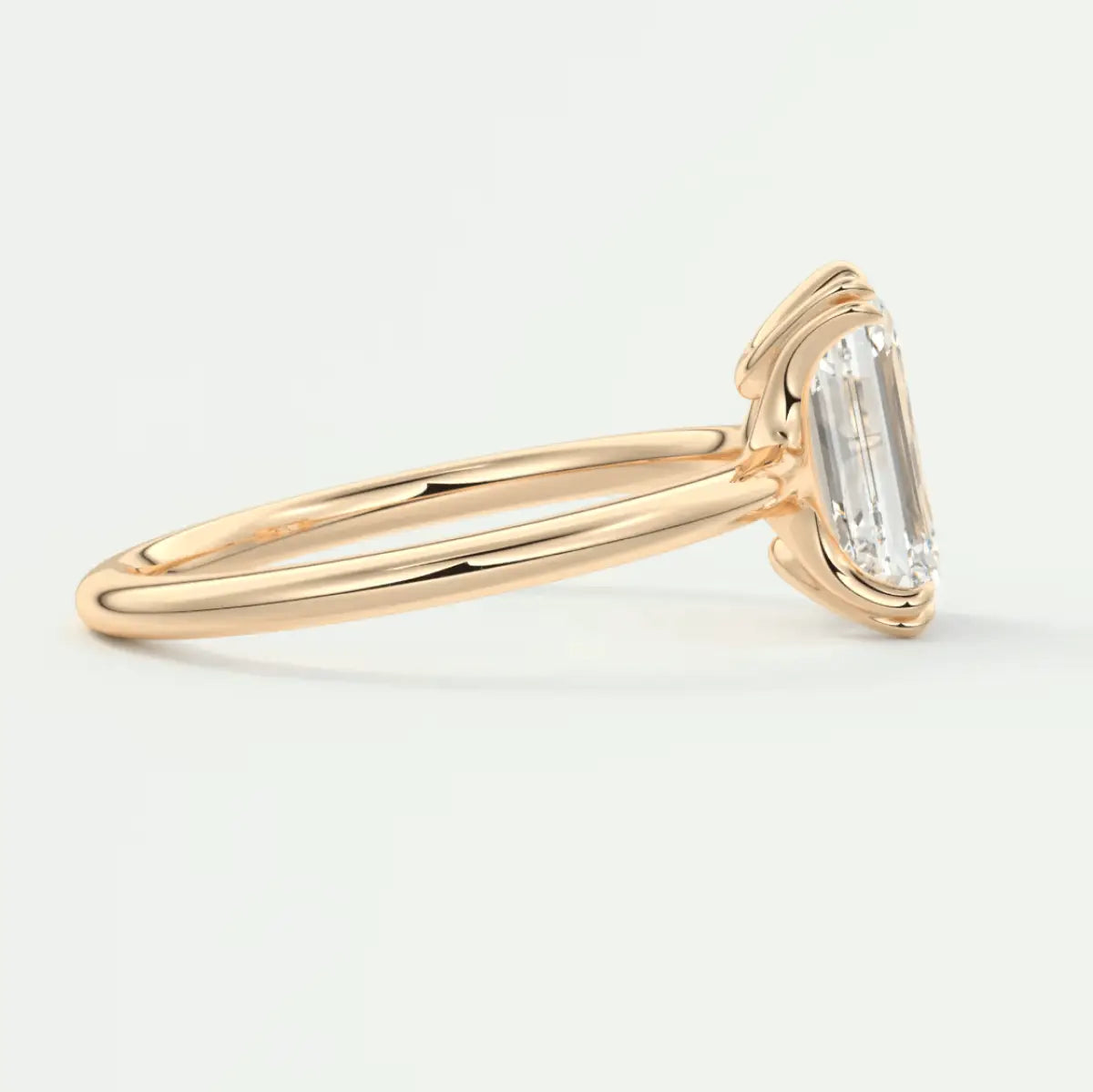 18k yellow gold emerald-cut diamond engagement ring with a classic solitaire design.