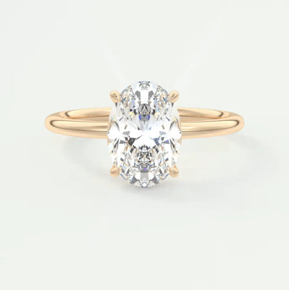 18-karat yellow gold oval diamond engagement ring with a solitaire design.