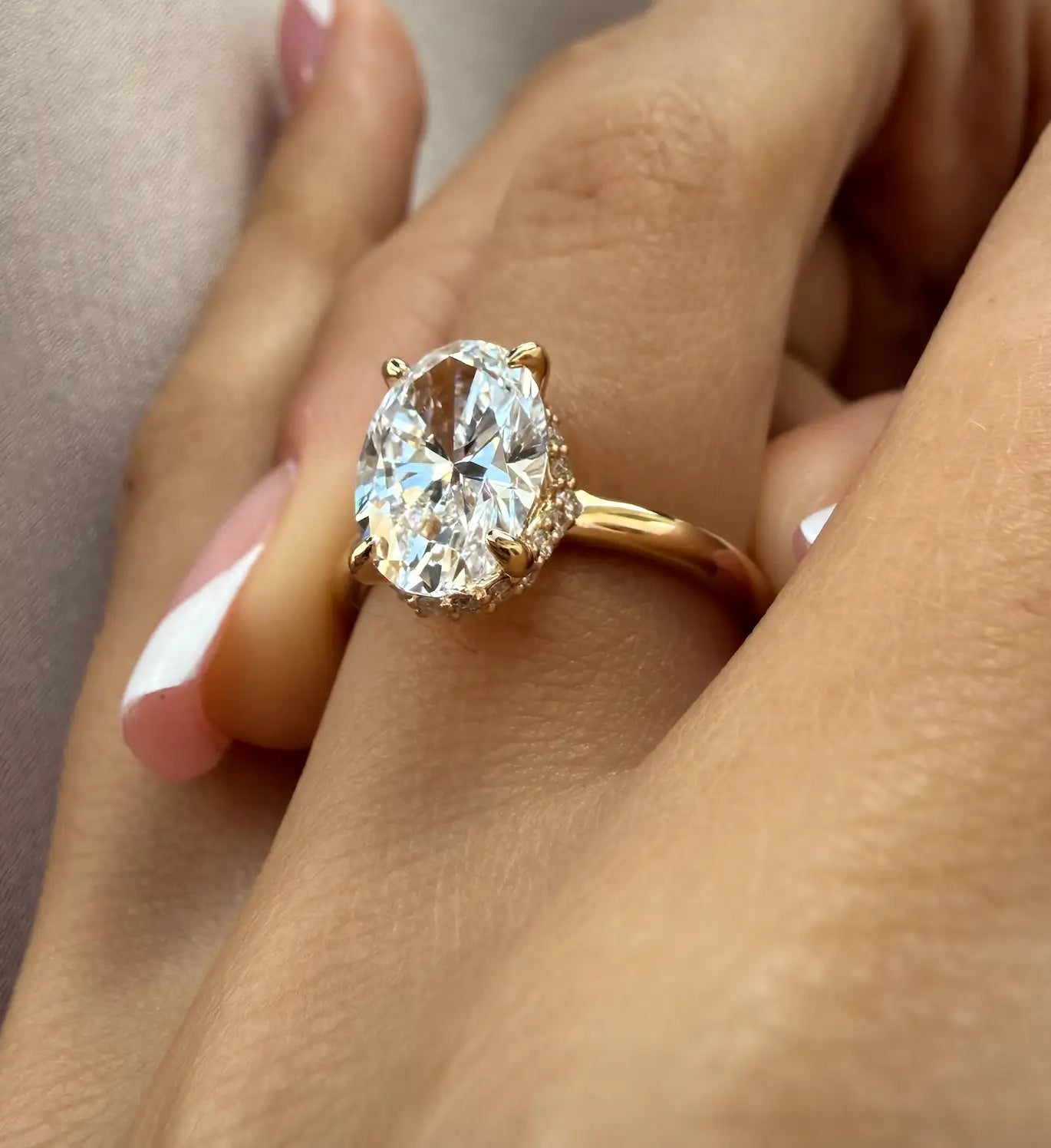 Gold ring with a large diamond on a hand