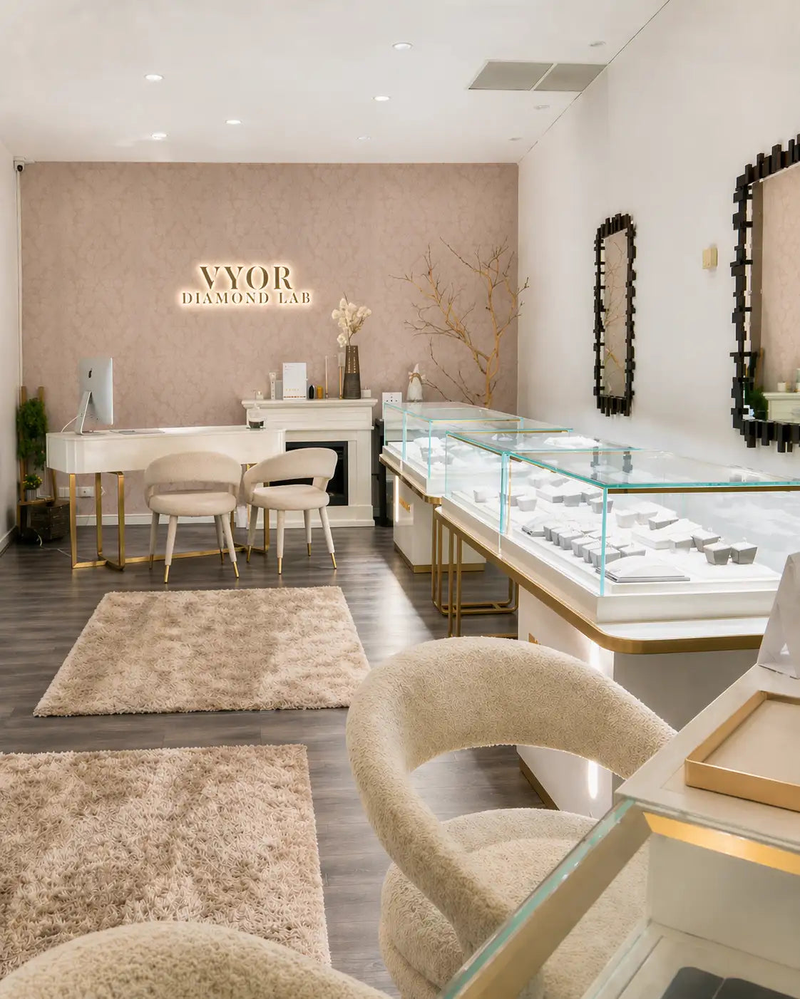 Interior of a jewelry store with display cases and seating area.