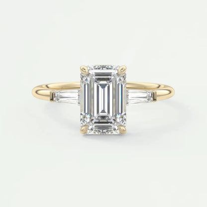 Custom made elysian emerald three-stone engagement ring with tapered baguettes