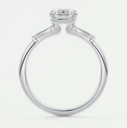 Custom made elysian emerald three-stone engagement ring with tapered baguettes
