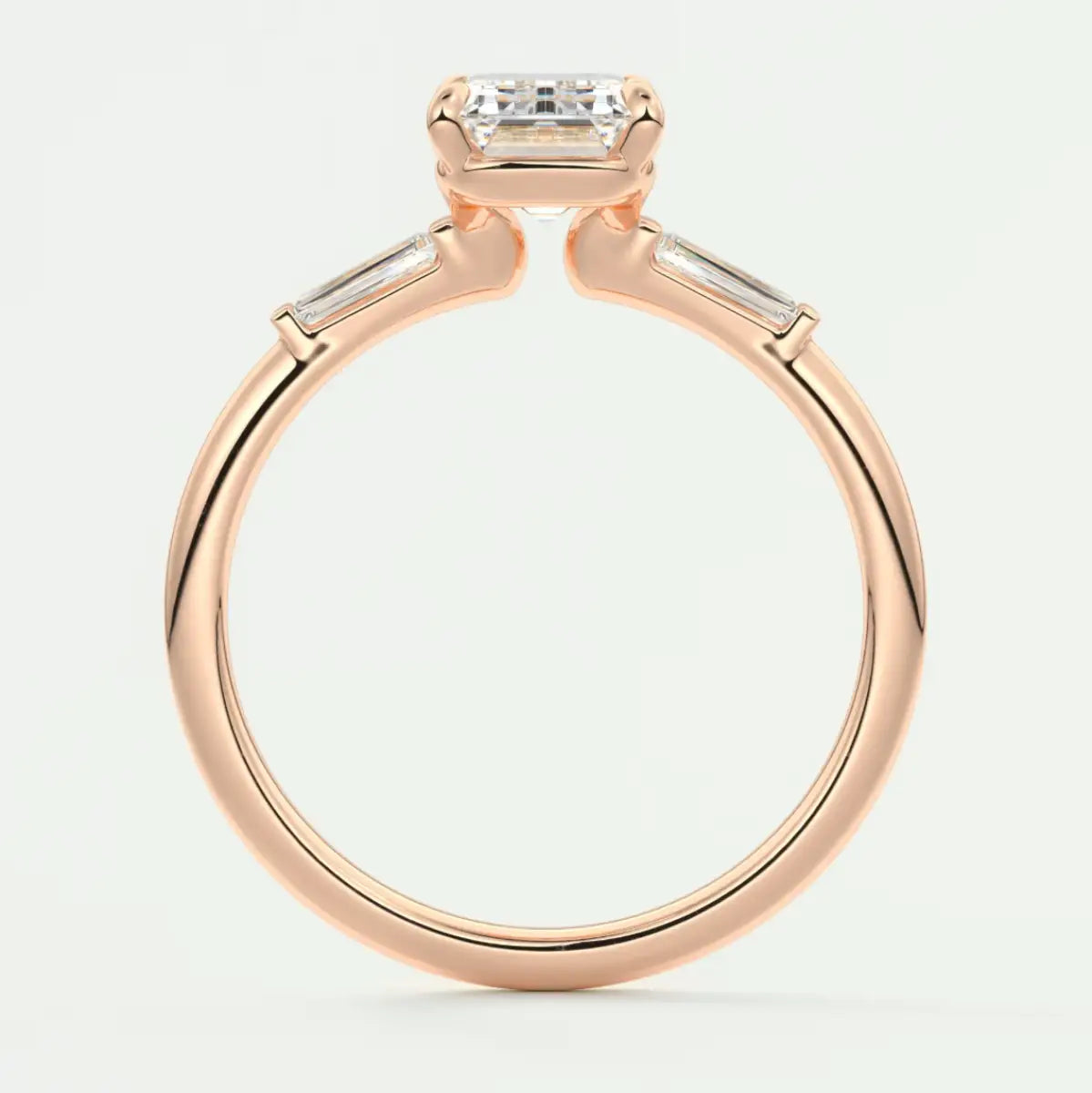 Custom made elysian emerald three-stone engagement ring with tapered baguettes