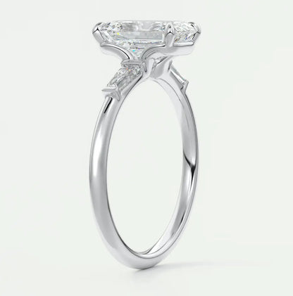 Custom made elysian emerald three-stone engagement ring with tapered baguettes