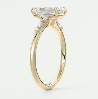 Custom made elysian emerald three-stone engagement ring with tapered baguettes