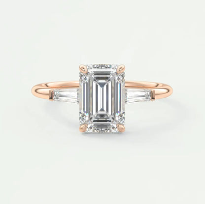Custom made elysian emerald three-stone engagement ring with tapered baguettes