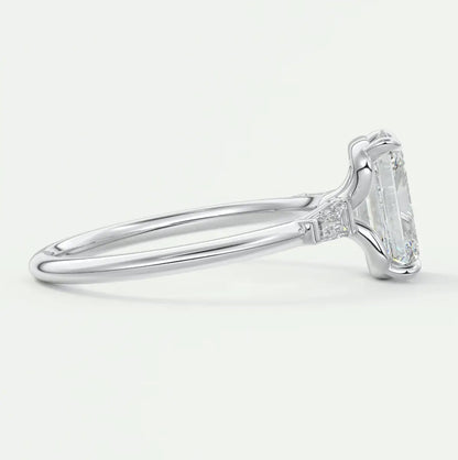 Custom made elysian emerald three-stone engagement ring with tapered baguettes