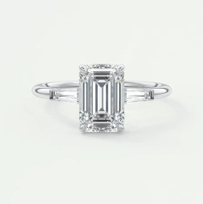 Custom made elysian emerald three-stone engagement ring with tapered baguettes