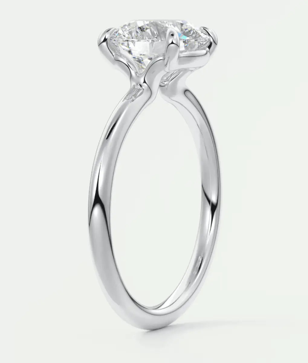 18-karat white gold solitaire engagement ring with a round diamond.