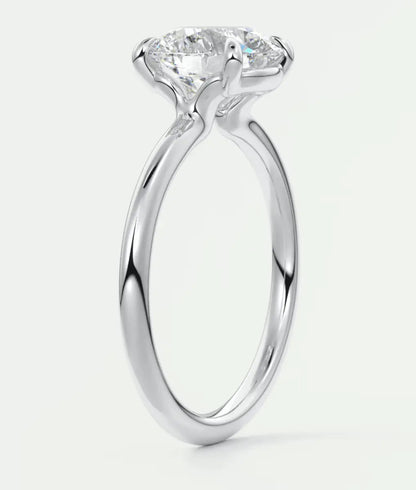 18-karat white gold solitaire engagement ring with a round diamond.