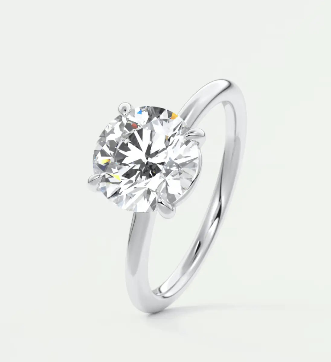 18-karat white gold solitaire diamond engagement ring.
