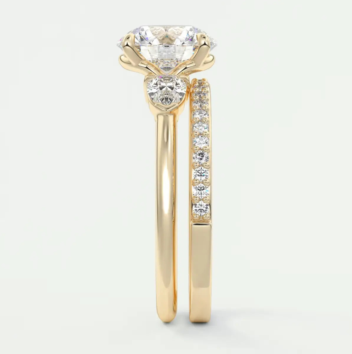 Custom made elysian round three-stone engagement ring with pear side stones | diamond lab