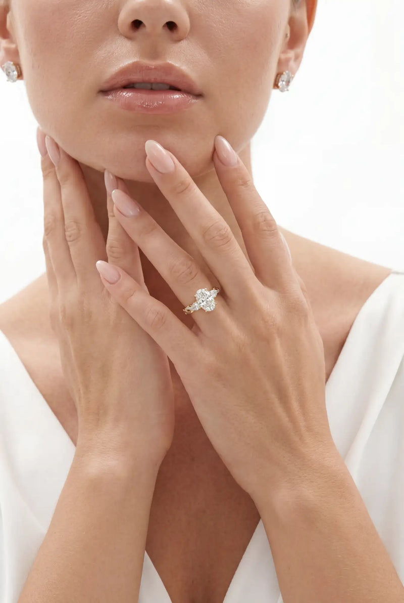 Close-up of a woman wearing a diamond ring on a white background
