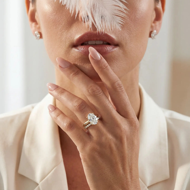 Close-up of a woman wearing a diamond ring with a blurred background