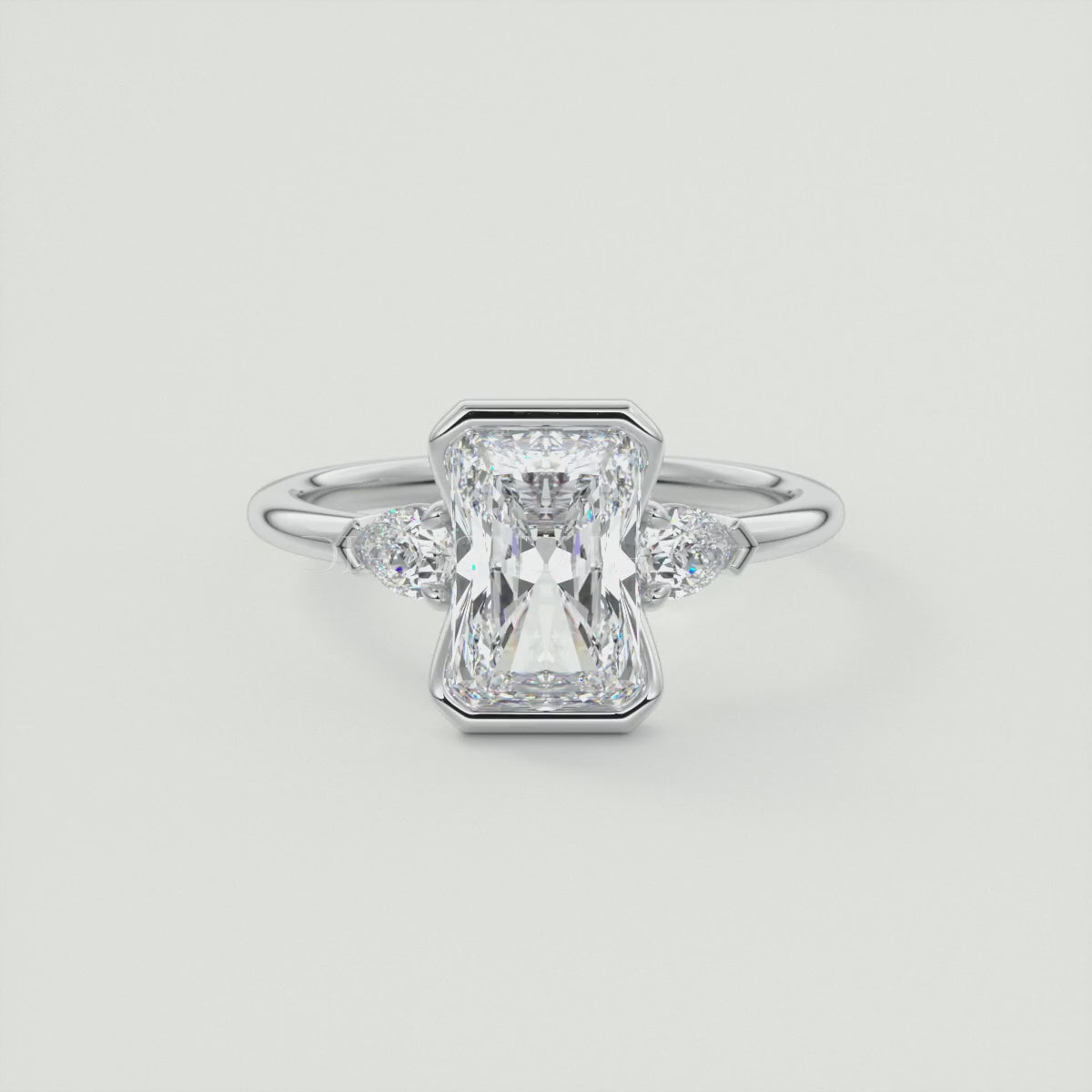 Solara Elongated Radiant Half Bezel Three-Stone Engagement Ring