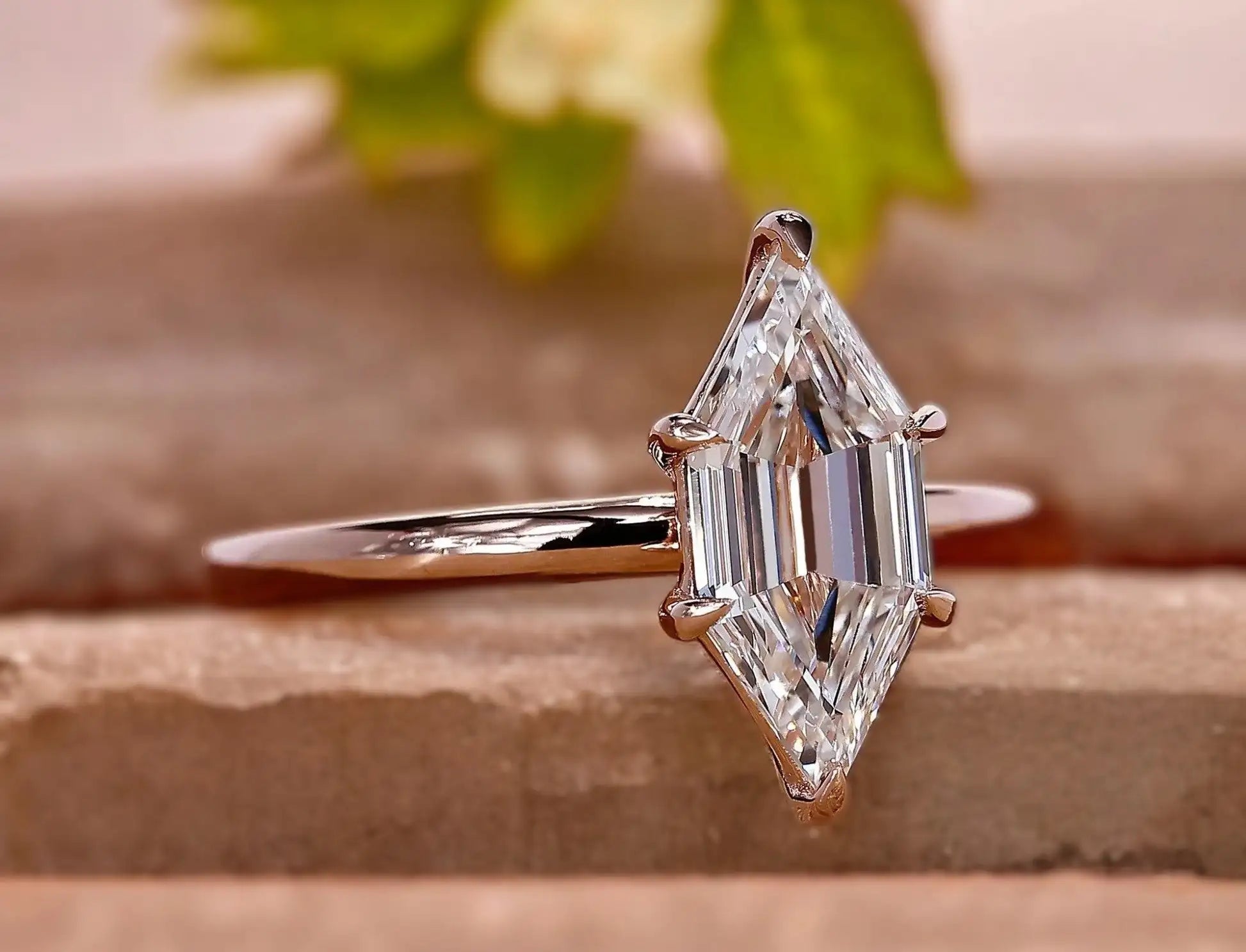 A radiant emerald-cut diamond ring set in a sleek rose gold band.
