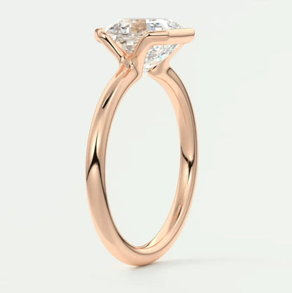 Rose gold engagement ring with a marquise-cut diamond.
