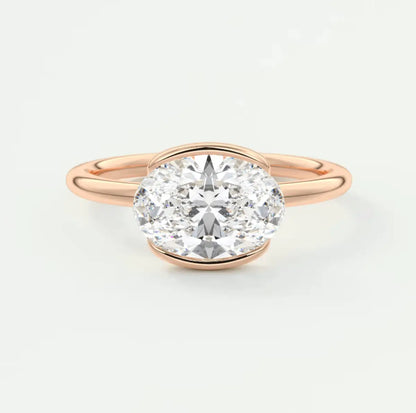 Rose gold oval diamond engagement ring with a solitaire design.