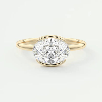 18k yellow gold oval diamond engagement ring with a bezel setting.