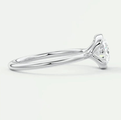 18k white gold solitaire engagement ring with a round diamond.
