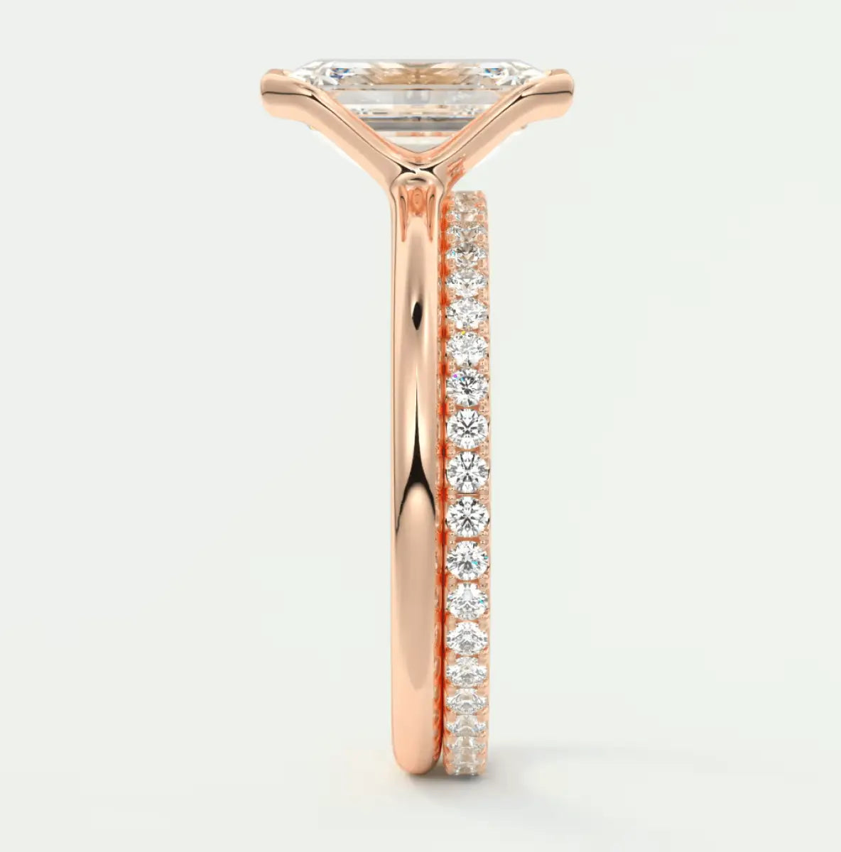 18k rose gold engagement ring with princess cut diamond and pave set diamonds on band.