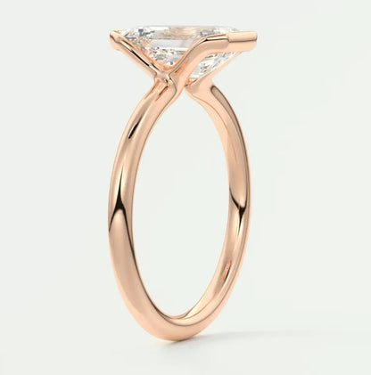 Rose gold princess cut diamond engagement ring with a twisted band design.