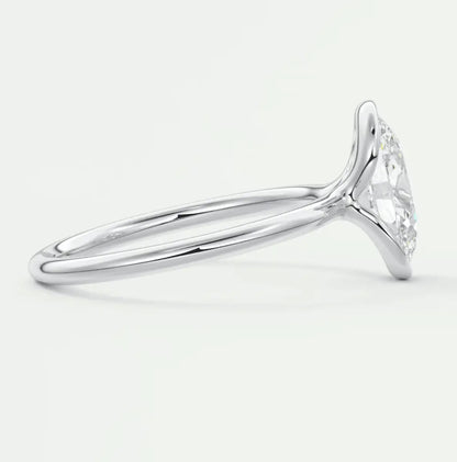 White gold diamond engagement ring with a marquise-cut center stone and intricate halo design.