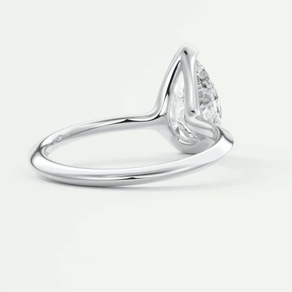 Pear-shaped diamond engagement ring with white gold band, featuring a classic solitaire design.