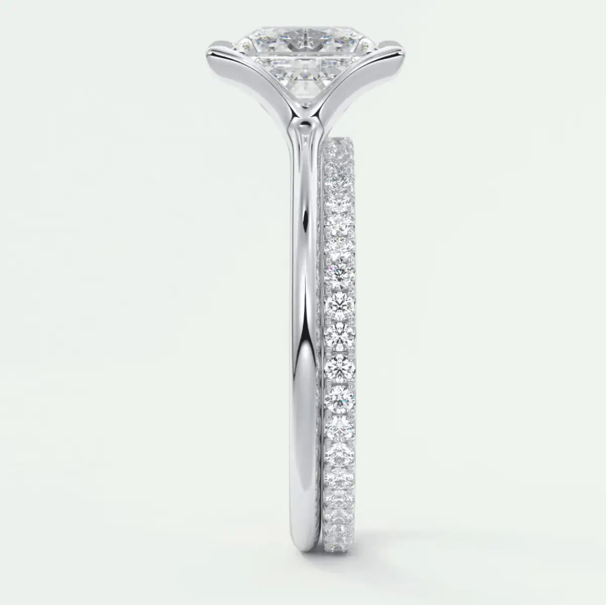 18k white gold diamond engagement ring with a princess cut center stone and pave set diamonds on the band.