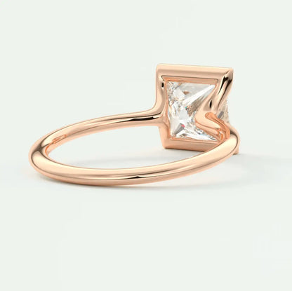 Rose gold princess cut diamond engagement ring with a square band.