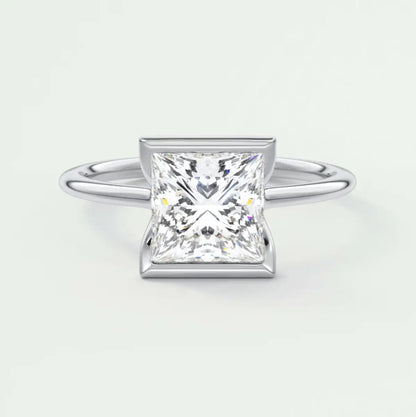Princess cut diamond engagement ring with white gold band and bezel setting.