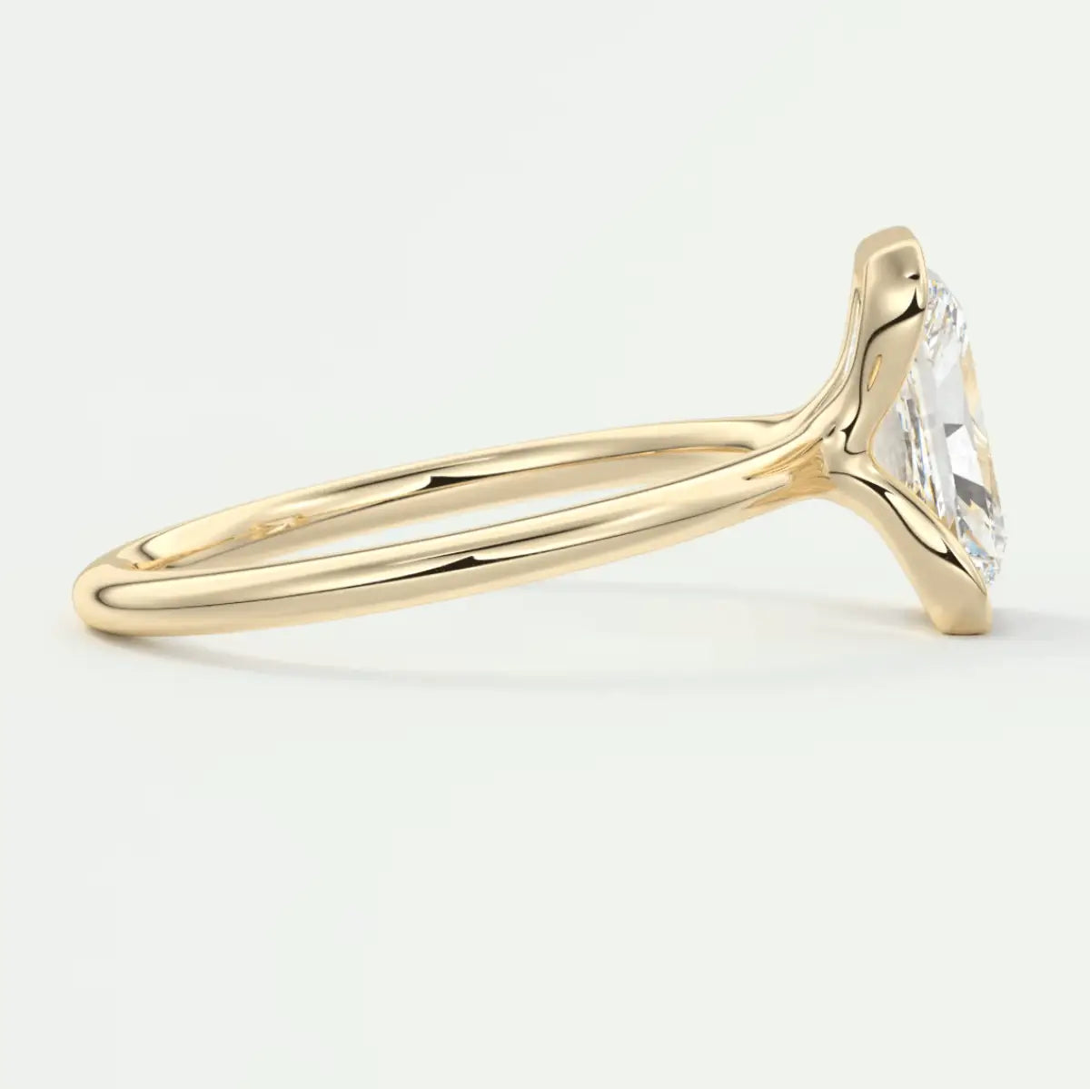 18k yellow gold engagement ring with a cushion-cut diamond.