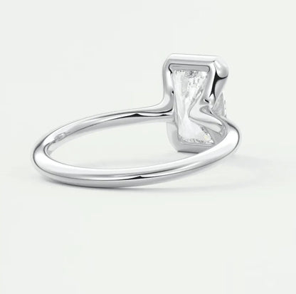 Silver rectangular diamond engagement ring with a polished finish and prong setting.