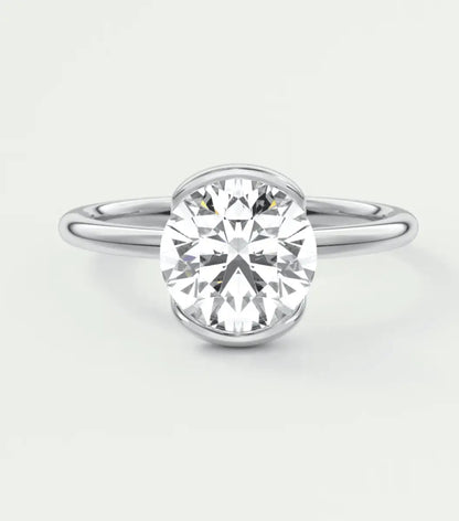 18-karat white gold solitaire diamond engagement ring.
