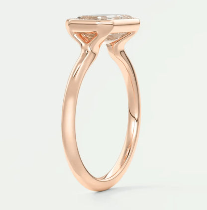 18-karat rose gold engagement ring with a cushion-cut diamond.