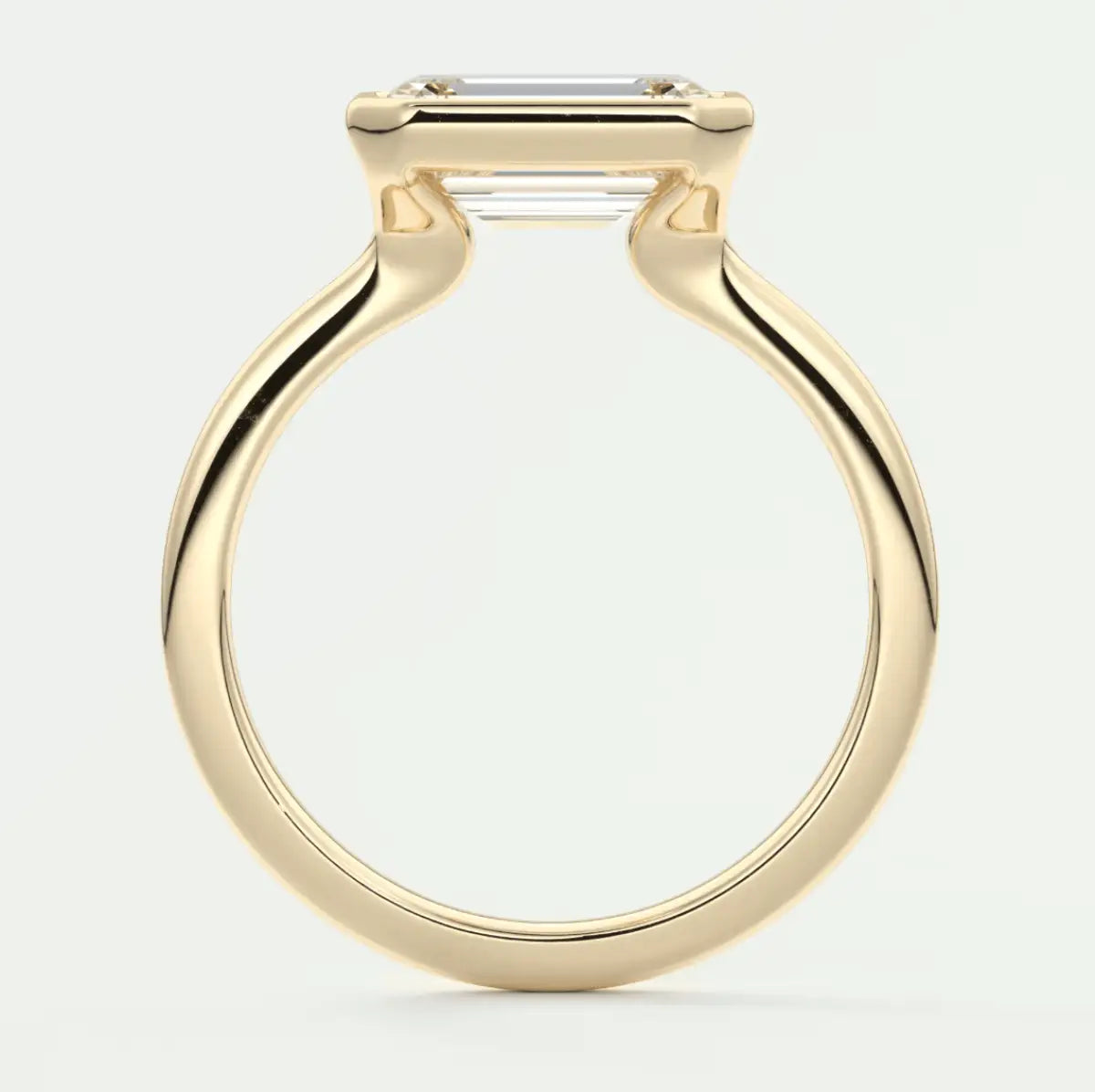 18k yellow gold engagement ring with an emerald-cut diamond.