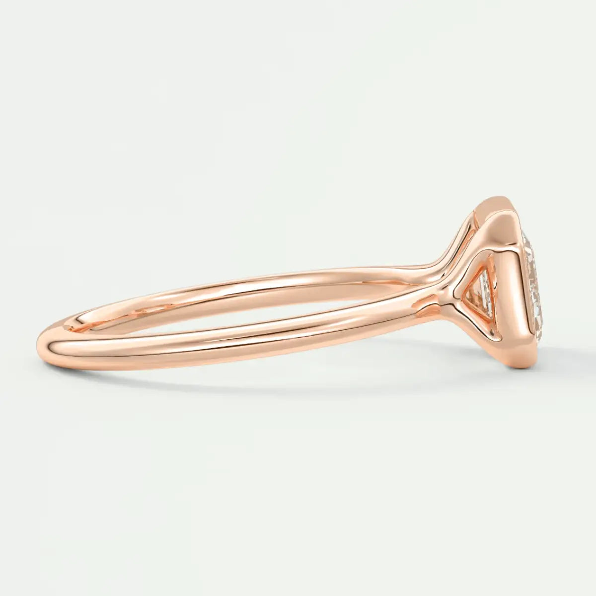 Rose gold diamond engagement ring with a cushion-cut center stone and delicate band design.