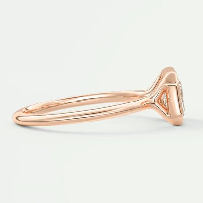 Rose gold diamond engagement ring with a cushion-cut center stone and delicate band design.